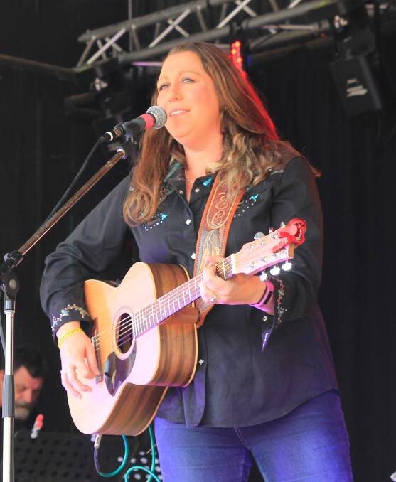 COUNTRY GIRL: Bec Hance, a guest artist from 2015, rocks out with her guitar on the Illabo Stampede stage. This year offers three guest artists, one more than usual. 