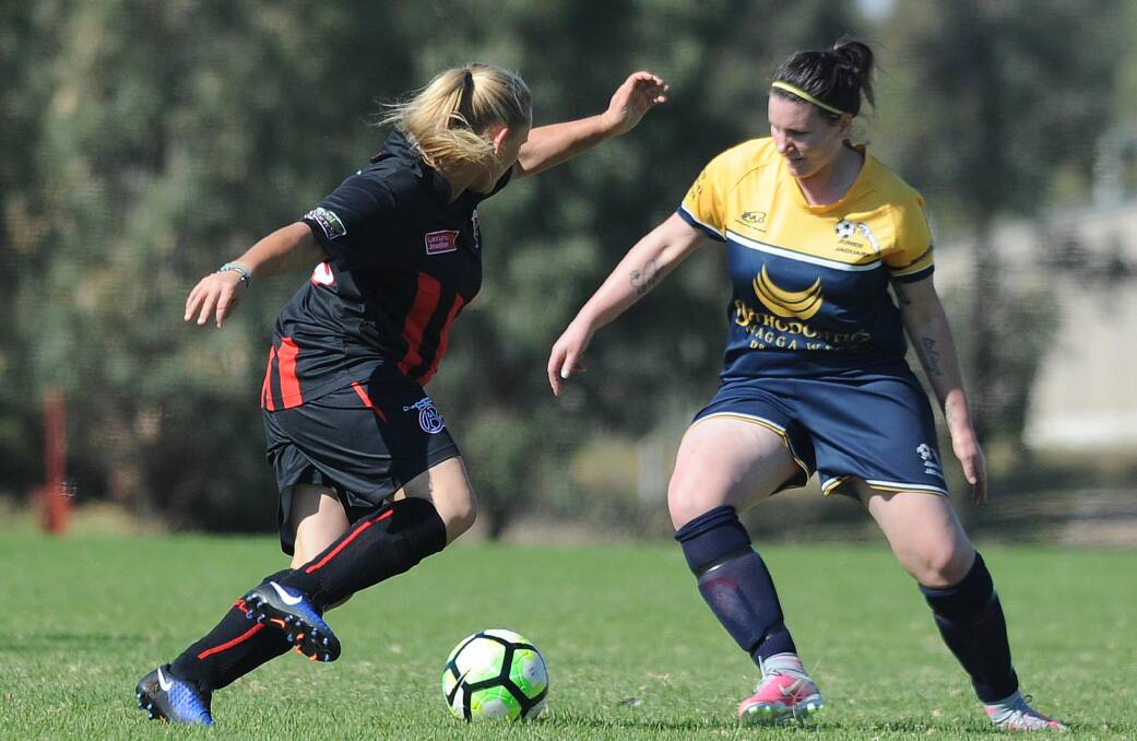 Junee's Ashleigh Goode takes on Leeton's Joni Lucas. The two sides will meet again at Burns Park on Sunday. 