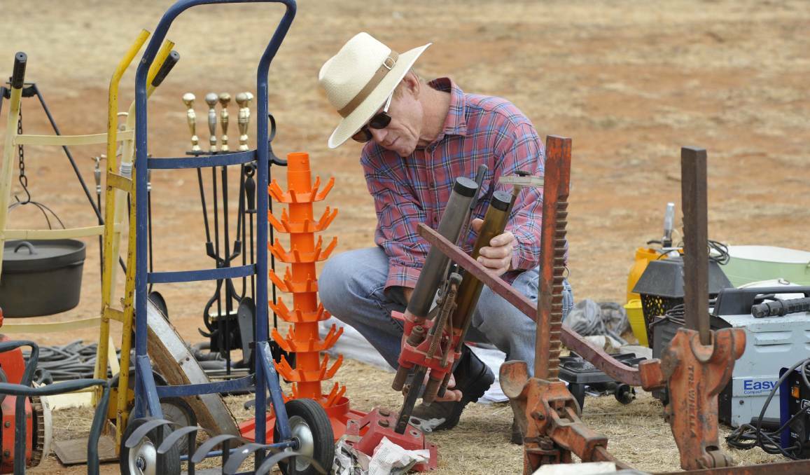 Stuart Kanaley examines some pumps at the Junee Swap Meet in 2015. 