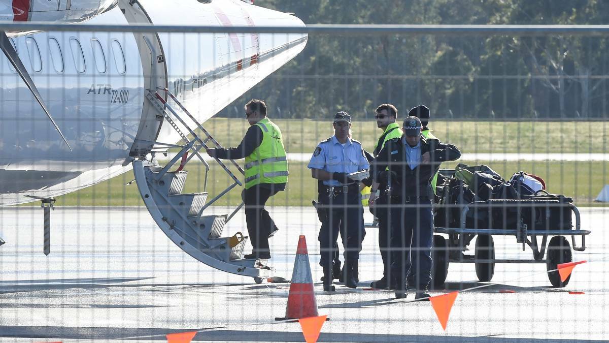 Police officers searched Virgin Australia flight VA1174 after a man was arrested on the tarmac shortly after the plane landed. Picture: Mark Jesser