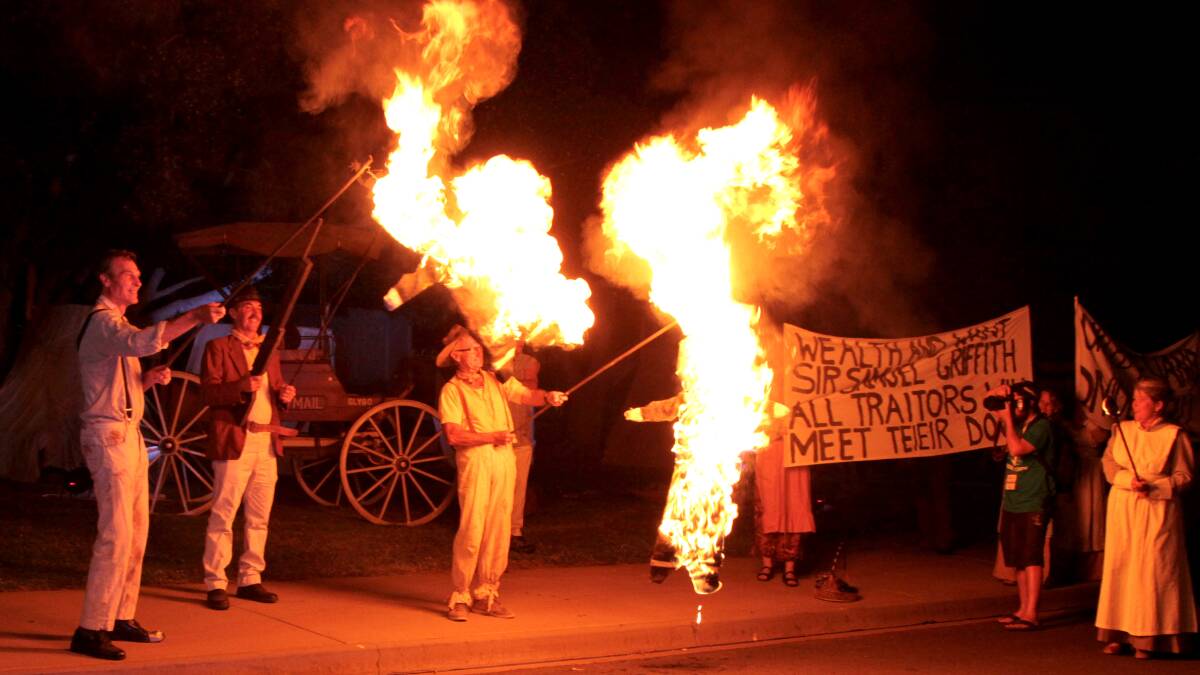 Aflame: Barcaldine locals re-enacted a February 1891 march, complete with burning effigies of 'Barcoo' Murphy and then-Premier Samuel Griffith. Pictures: Sally Cripps.