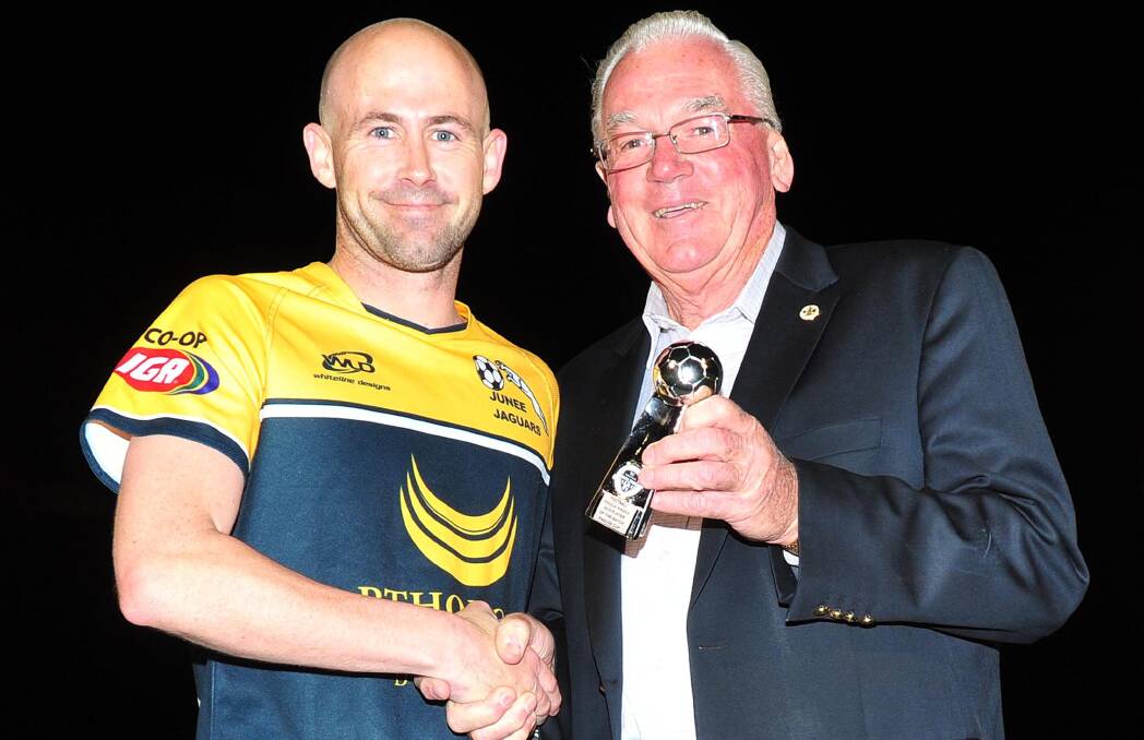 MAN OF THE MATCH: Junee's Ray Jones receives his man of the match trophy from Kerry Pascoe in his last game of soccer on Sunday. Picture: Kieren L Tilly