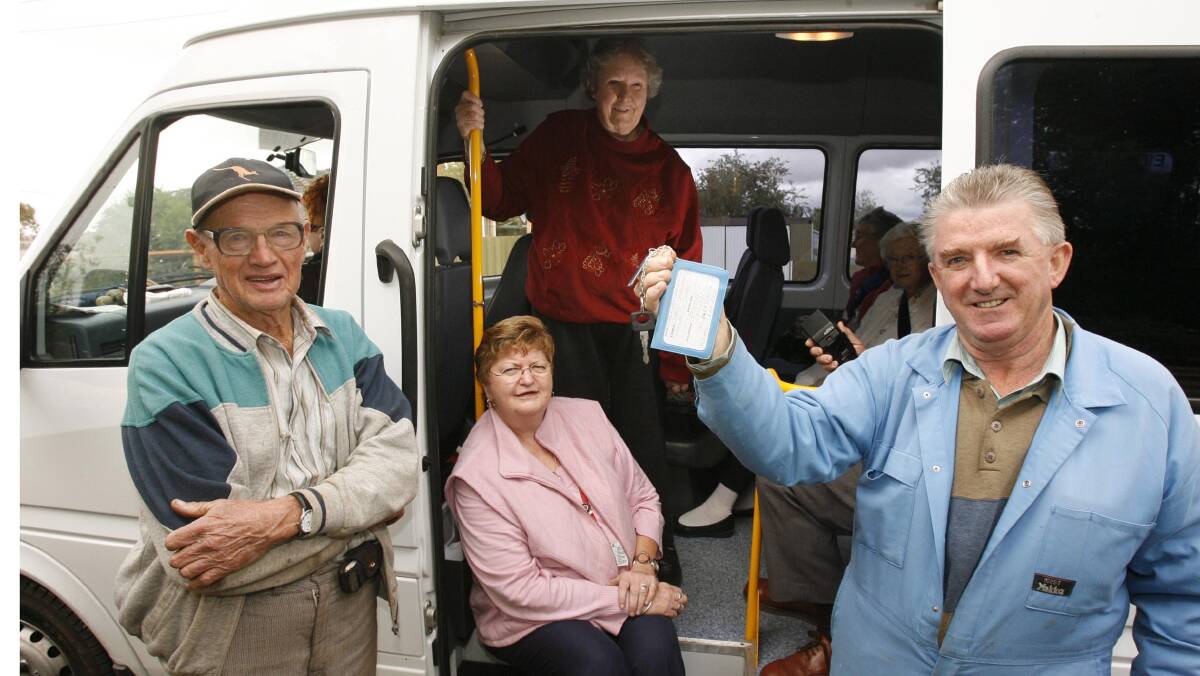 Dal Eisenhauer (far left) with the day care bus in 2007. Mr Eisenhauer has helped retain the service after the MLHD threatened to withdraw it.