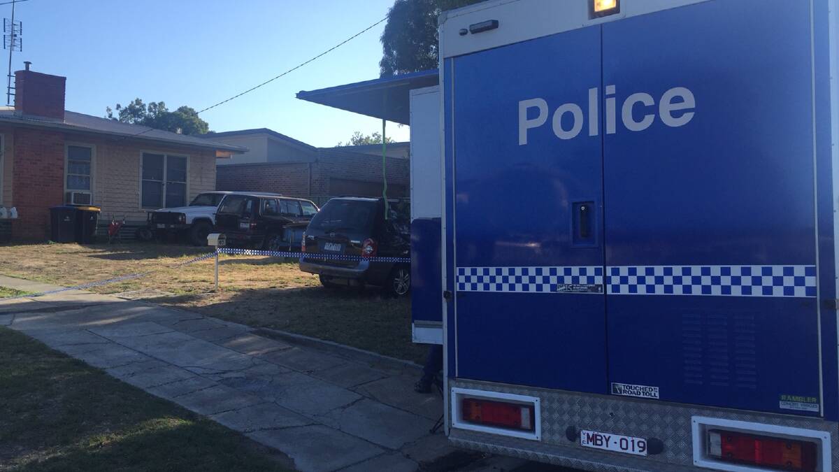 Police search a house in Kangaroo Flat