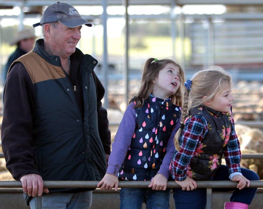 DAY OUT: Mick Heinjus of Junee, with his grandaughters Paige McAlister, 4, and Imogen Dobson, 4, at Wagga Sheep Sale.