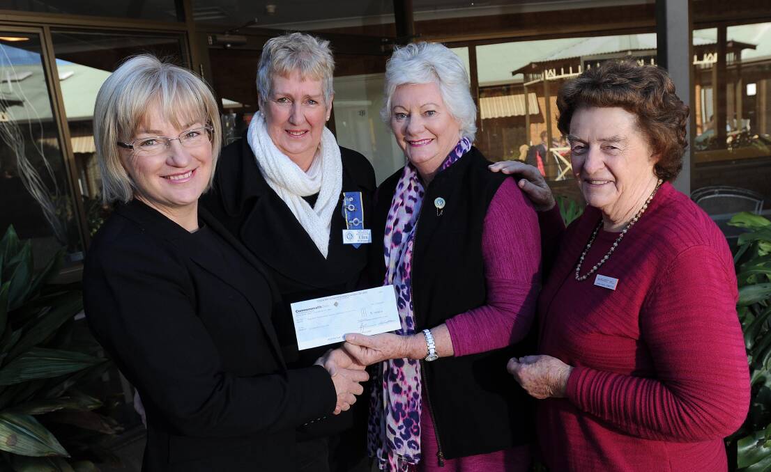 BIG EFFORT: Cooinda Court's Patricia Butler (left) and Margaret Hill (right) accept a cheque from Hume Group CWA's Ellen Williams and Gail Commens.