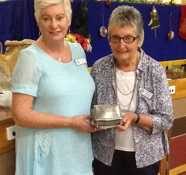 CONGRATULATIONS: Gail Commens, ACWW South Pacific Area President, presents the trophy for international needlework to Alison Lehmann, Dirnaseer branch.
