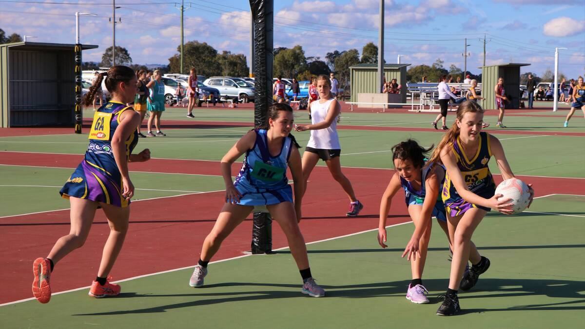 NETBALL: Brooke Harpley reaches for the ball, assisted by Jacinta Cooper. Picture: Contributed