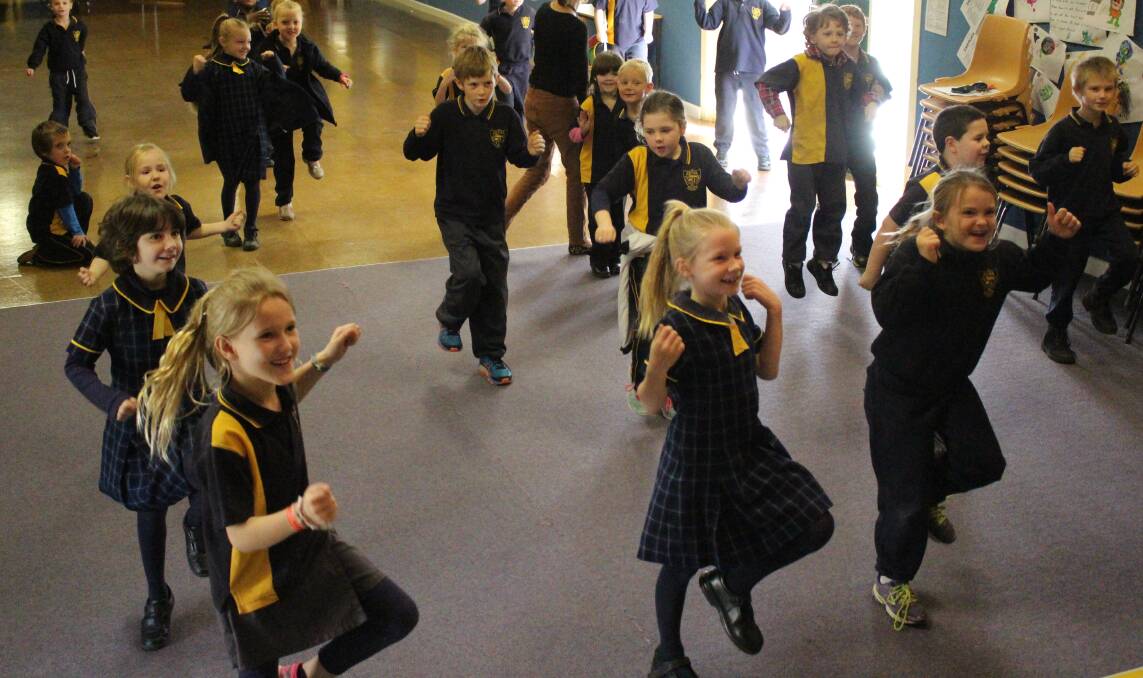 DANCING QUEENS: Kindergarten kids holding nothing back. Picture: Madeleine Clarke