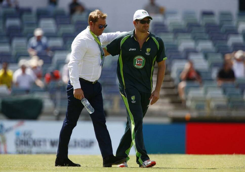 There, there mate: Australian cricketer Shane Watson walks with former Australian cricketer Shane Warne before Australia's Cricket World Cup match against Afghanistan in Perth. Photo: Reuters 