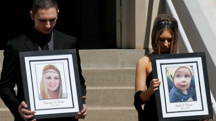 Relatives of Bianka and Jude O'Brien carry their photographs at their funeral. Photo: Daniel Munoz
