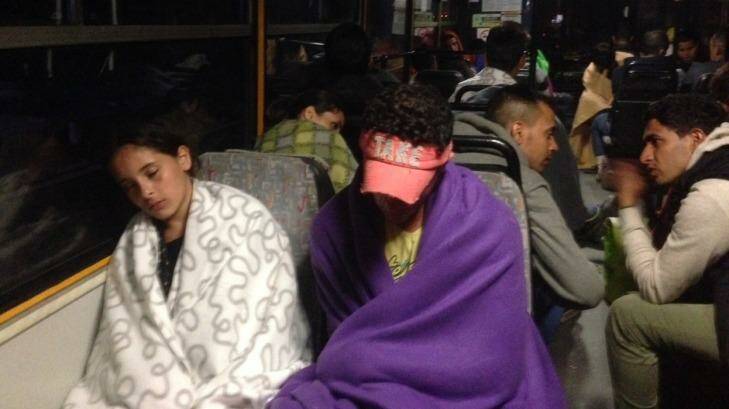 Migrants sleep on the bus as it leaves Hungary early on Saturday. Photo: David Maurice Smith