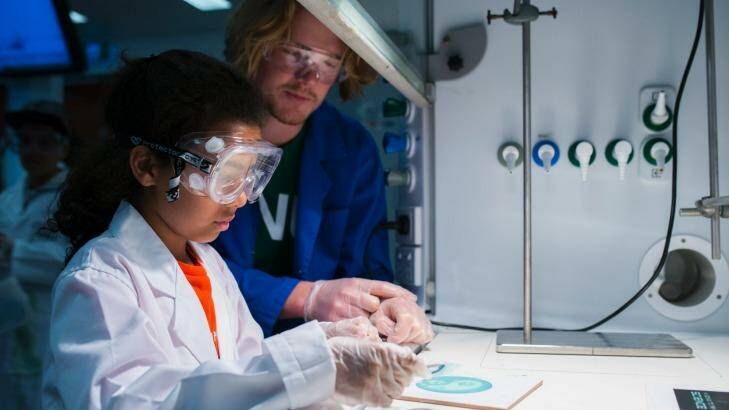 Suli Stewart, 9, with PhD student Joe Kaczmarski making a blueprint in the chemistry lab. Photo: Rohan Thomson