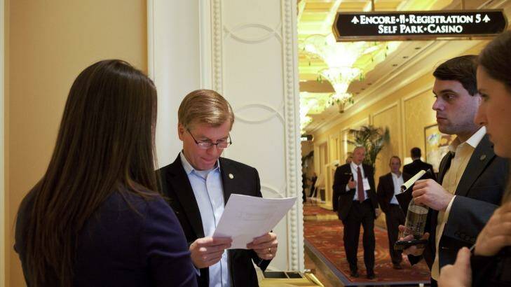 Bob McDonnell (with papers) at a conference in Las Vegas in 2012.   Photo: New York Times