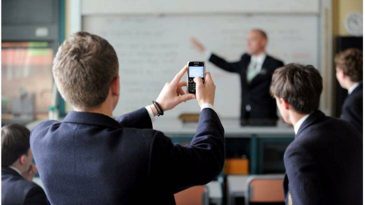 Students at a school in Melbourne use their mobile phones in class. Photo: Craig Abraham