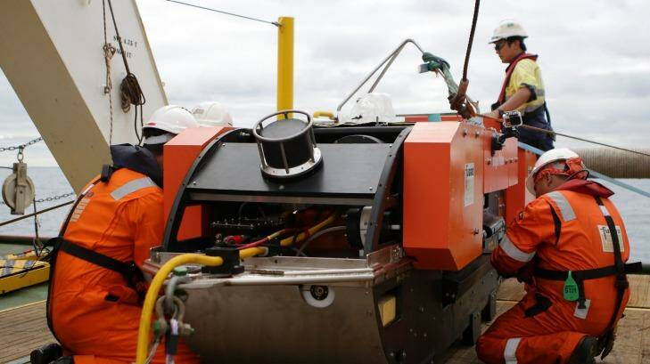 Last checks are done on the Dragon Prince deep tow fish prior to deploying it behind Fugro Discovery. Photo: Fairfax