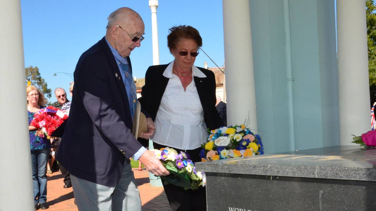 Anzac day in Junee. Roger Quine and Lola Cummins lay a wreath for Junee Rotary. Picture: Declan Rurenga
