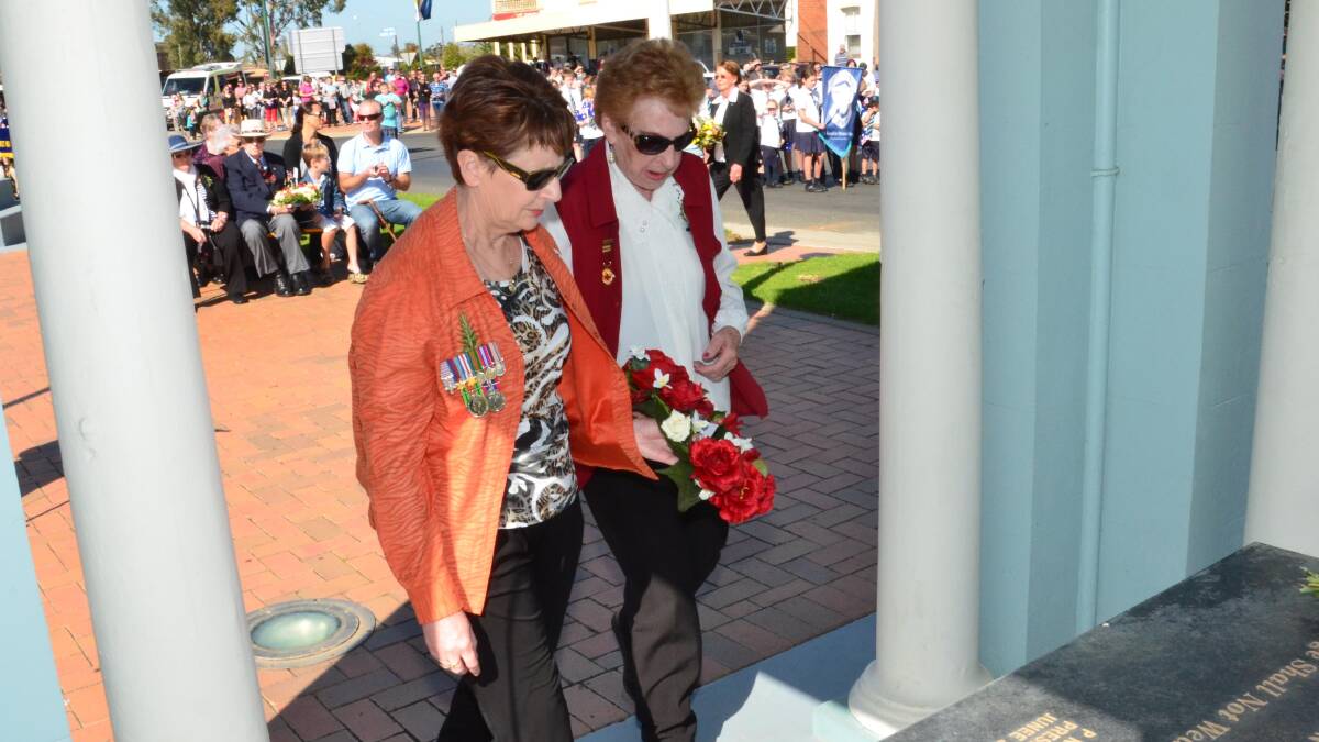 Anzac day in Junee. Jenny Morton and Brenda Schultz lay a wreath for Junee-Illabo Red Cross. Picture: Declan Rurenga