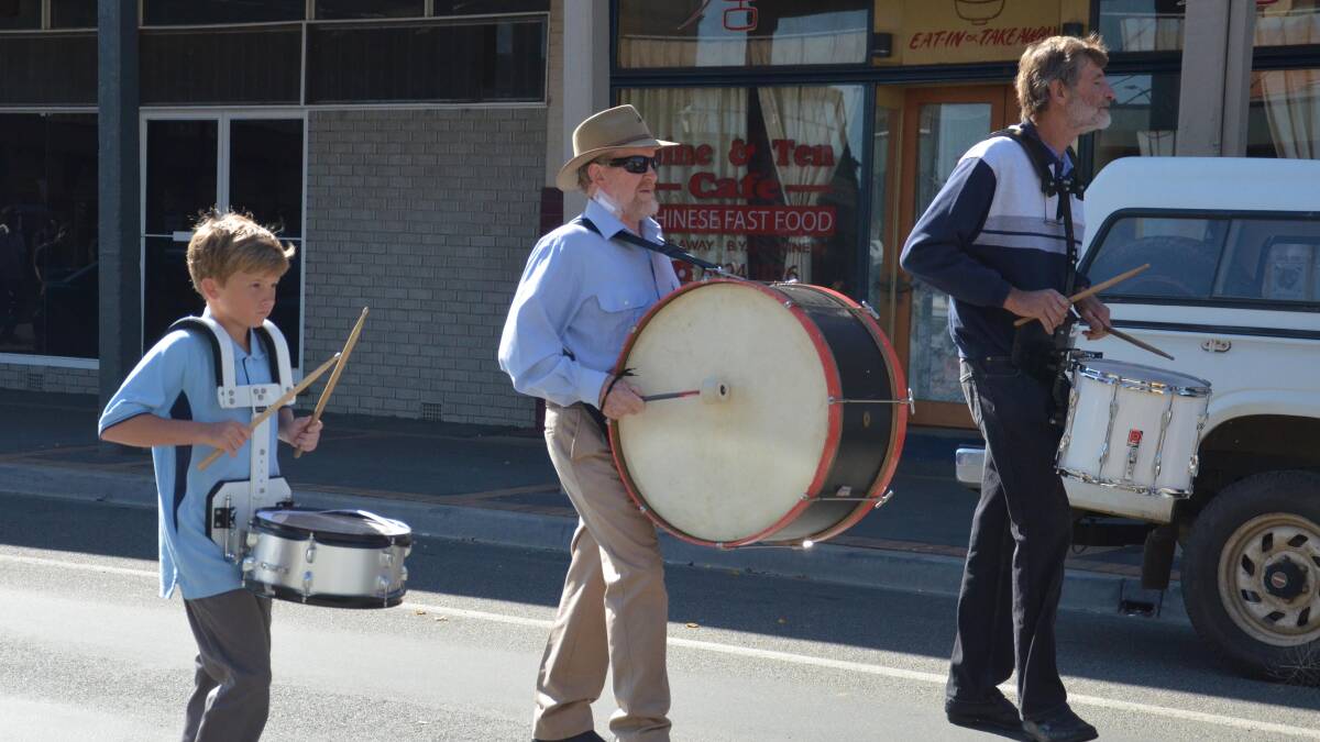 Anzac day in Junee. Josh Hogarth, 12, Nick Lehmann and Noel "Tack" Lawrence keep the beat for marchers. Picture: Declan Rurenga