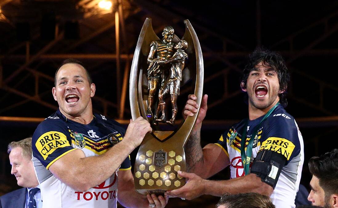 Matthew Scott and Johnathan Thurston of the Cowboys hold the Premiership trophy aloft as they celebrate victory during the 2a015 NRL Grand Final match between the Brisbane Broncos and the North Queensland Cowboys at ANZ Stadium on October 4, 2015 in Sydney, Australia. Photo by Mark Kolbe/Getty Images