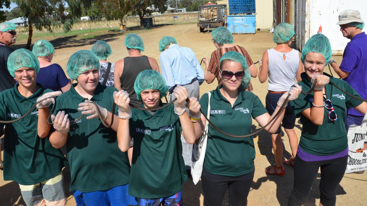 Local volunteers Raymond Hocking, 13, Logan Fletcher, 14, Ricky Russell, 14, Jayde McDermott, 14 and Teagan McCormack, 14 take part in the world's longest licorice strap attempt. Picture: Declan Rurenga