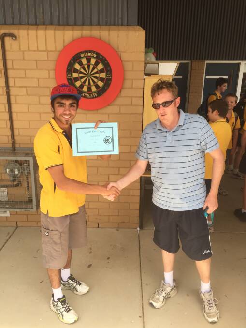Sonny "Bullseye" Punch is congratulated by Junee High School teacher William Lea after winning the inaugural darts championship. Picture: Junee High School