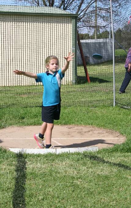 Madeline Jellett, 6 throws her discus. Picture: Declan Rurenga
