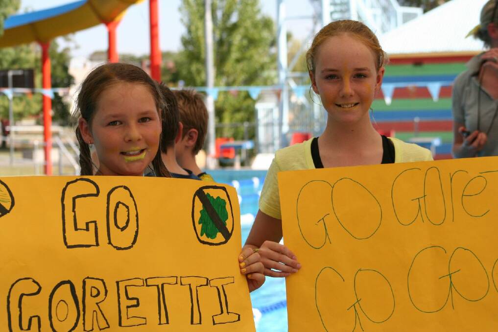 Brooke Harris, 10 and Abbi Duck, 11, get behind Goretti Sports House for St Joseph's Primary School's swimming carnival. Picture: St Joseph's Primary School