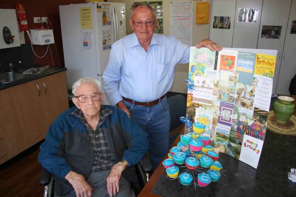 Junee's oldest resident Noel Edson celebrates his 105th birthday with this son Bernie and friends at the Junee MPS with the help of 105 cupcakes last week. Picture: Declan Rurenga
