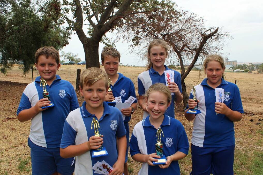 Junee North Public’s swimming champions (back, from left) Lachlan Payne, Lachlan Richards, Brooke Harpley, Tayla O'Rafferty, Joel Crowder (front, left) and Matilda McDevitt receive their trophies and ribbons. Picture: Junee North Public School