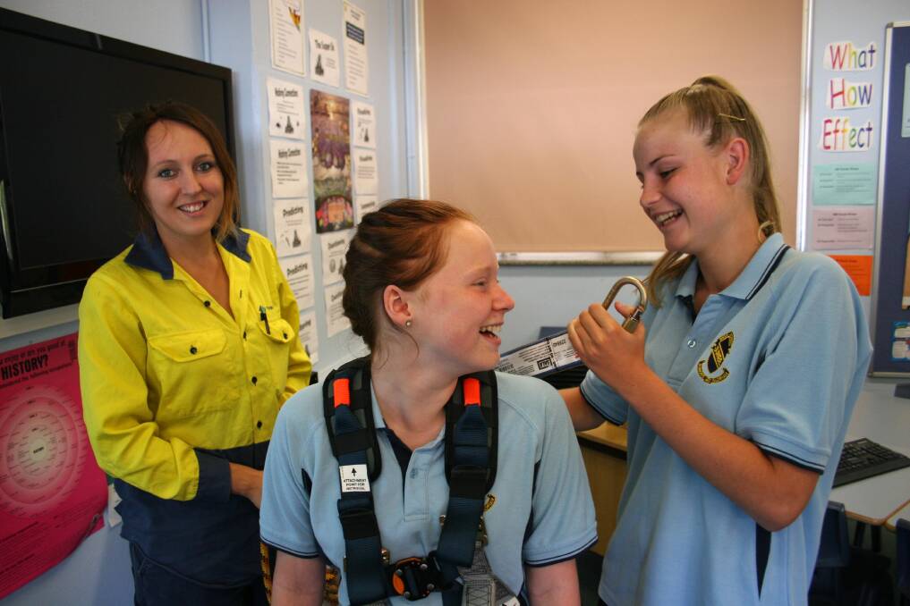 Junee High School year 7 students Charlie Tattersall (centre) and Caitlin Guinan try out some of the safety gear used by Transgrid’s Stephanie Puttock during the school's welfare day this week. Picture: Declan Rurenga