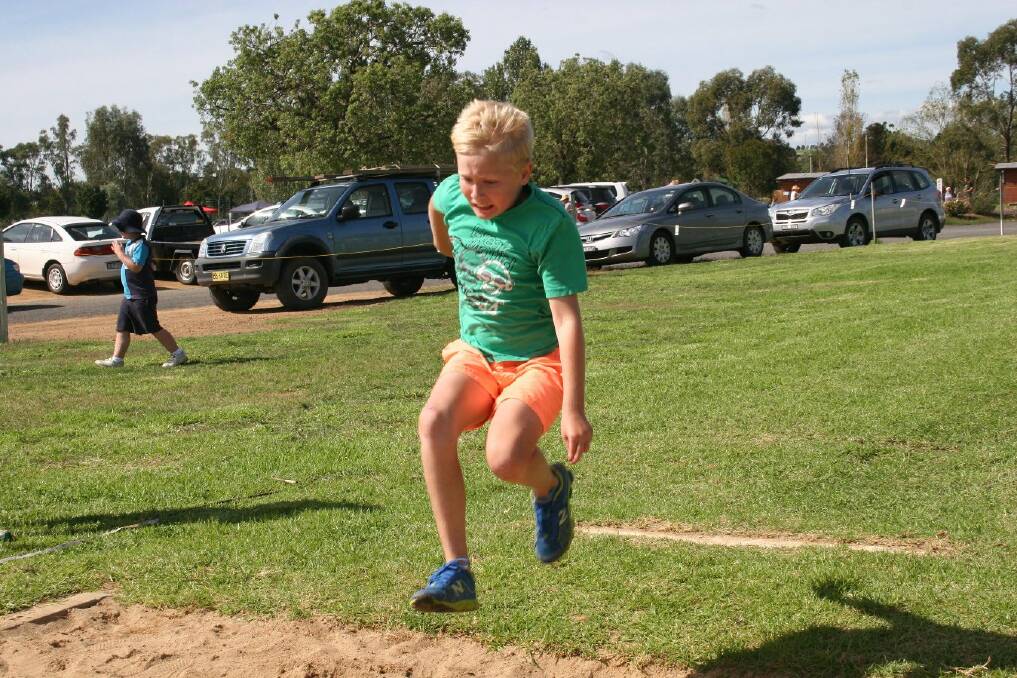 Jack McCarthy, 9 gets ready to land during long jump practice. Picture: Declan Rurenga