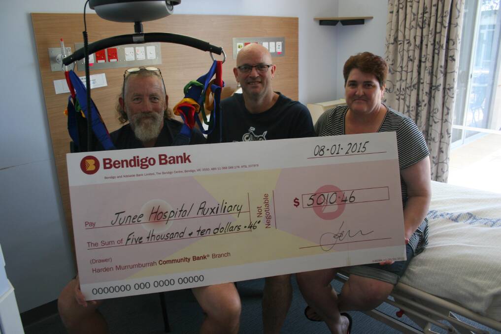 Sitting in one of the Junee Multi-Purpose Service’s chairlifts is Junee Motor Club secretary John Lawrence who is presenting a cheque with publicity officer Toby Bowering (centre) to Junee Hospital Auxiliary president Sharon Longmore. Picture: Declan Rurenga