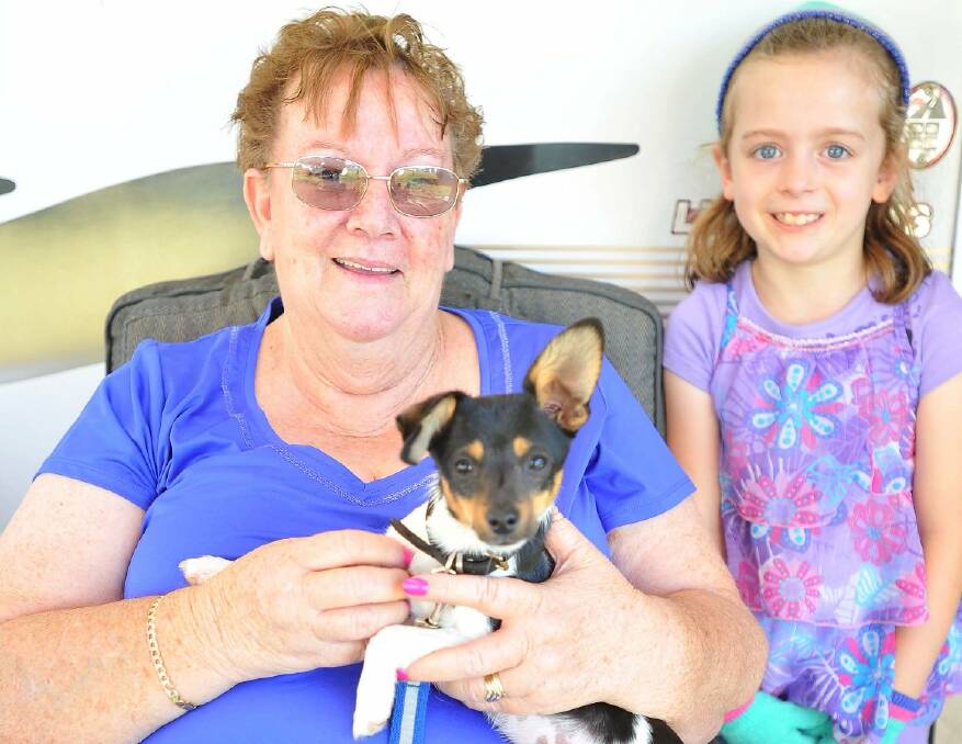 Junee's Bev Ross and Goulburns's Charlie Sneddon, 7 and Billy Bob the dog watch the show at Illabo. Picture: Kieren L Tilly