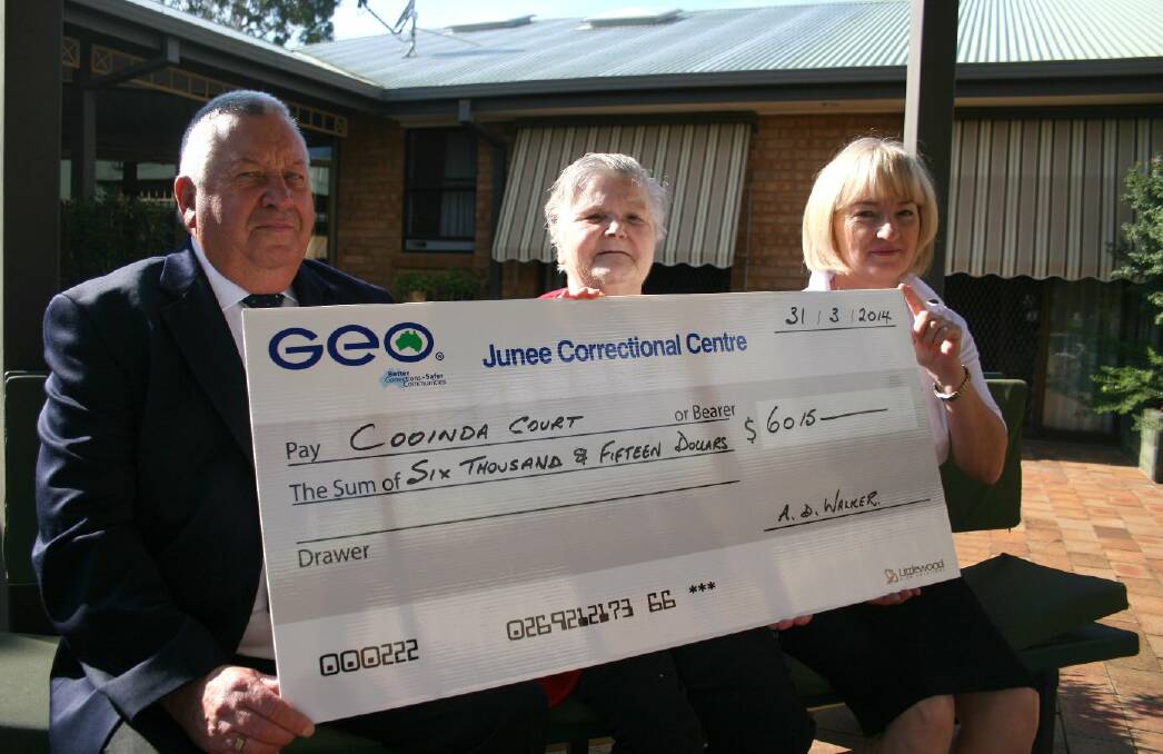 GEO Group general manager Andy Walker presents $6015 to Cooinda Court management committee president Patricia Butler and resident Winnie Walter to help with the retrofitting of fire sprinklers. Picture: Declan Rurenga