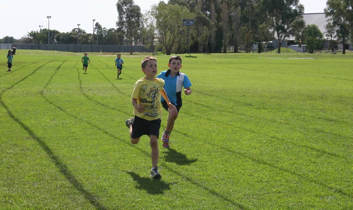 Tom Collins-McAllister, 8 (left) and Nate Riley, 8 come in second and third during the 200 metre sprint. Picture: Declan Rurenga