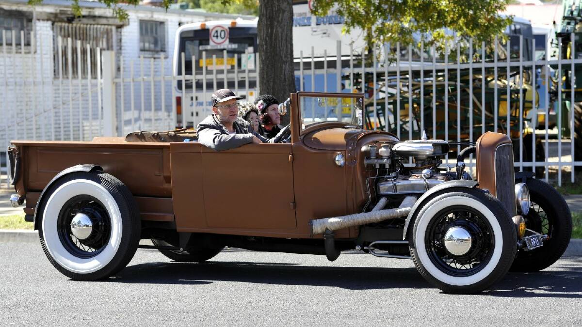 Phil, Scarlett, 11 and Carolyn Stokoe from Ashfield make their way into Junee in their 130 Model A Roadster pickup.