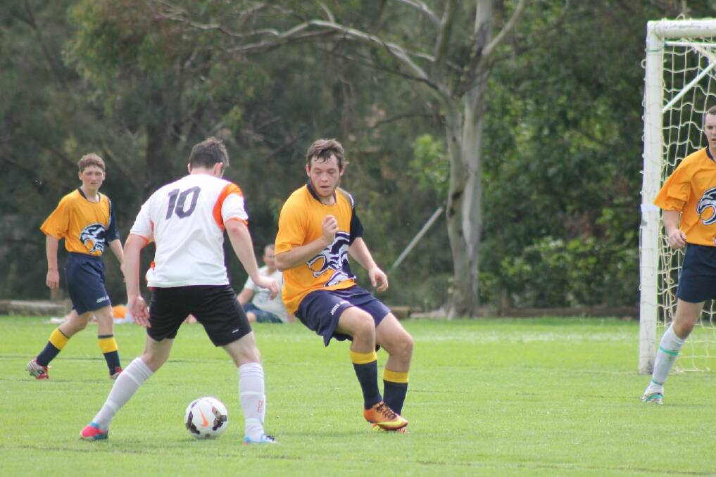 A Wagga United player tries to get past Junee's Kyle Betkowski. Picture: Melanie Miller