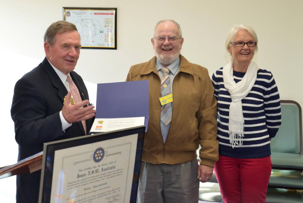 Past district governor Greg Brown presents the Paul Harris Fellowship to Junee Rotary member Graeme Guelfi and his wife Dorothy. Picture: Declan Rurenga