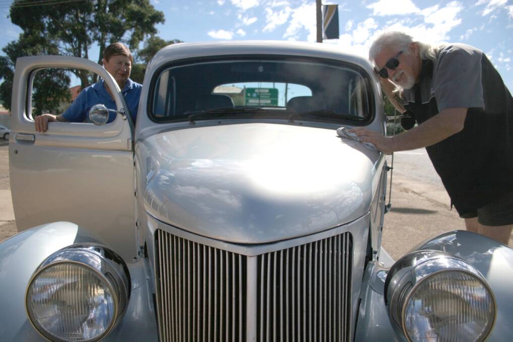 Cooinda Court management committee vice president Pam Halliburton and Wagga Custom and Rod Club member Peter "Silver" Ward gives his 1936 Ford Coupe utility a once over ahead of the 30th annual 'Rod Run' which will be in Junee on Saturday April 19. Picture: Declan Rurenga