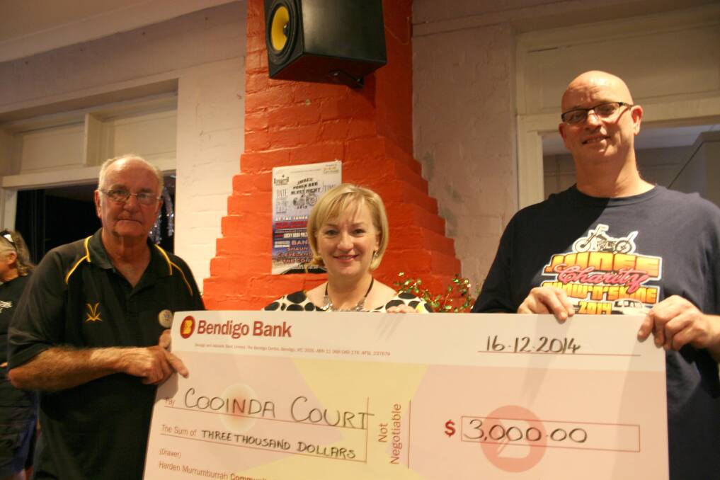 Junee Motor Club president Kevin Longmore (left) and publicity officer Toby Bowering present a cheque for $3000 to Cooinda Court's management committee president Patricia Butler. Picture: Declan Rurenga