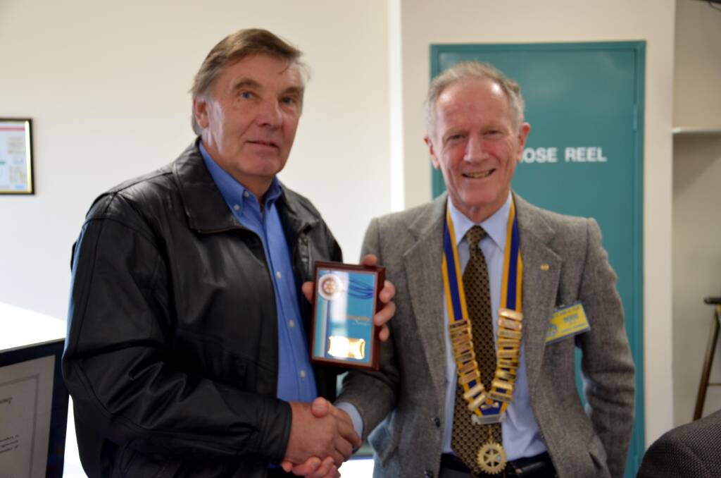 Volunteer Vince Hollis was presented with Junee Rotary's community service award by president Doug Bell. Picture: Declan Rurenga