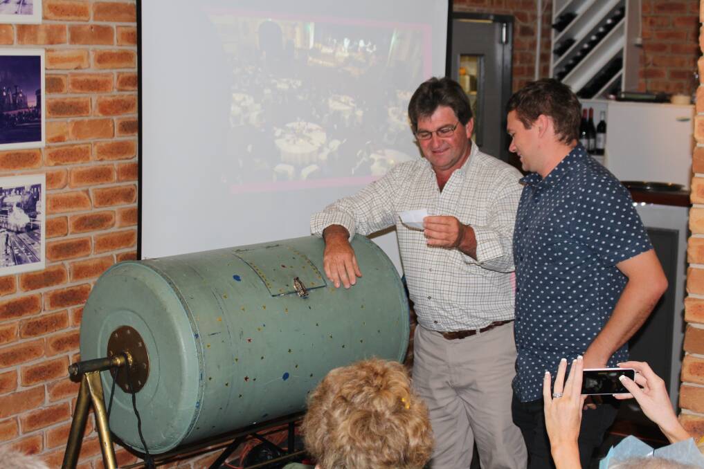 Junee Business and Trades president Tony Butt reads out the name of one of the raffle winners chosen by Mark Wright (right). Picture: Natalie Phillips