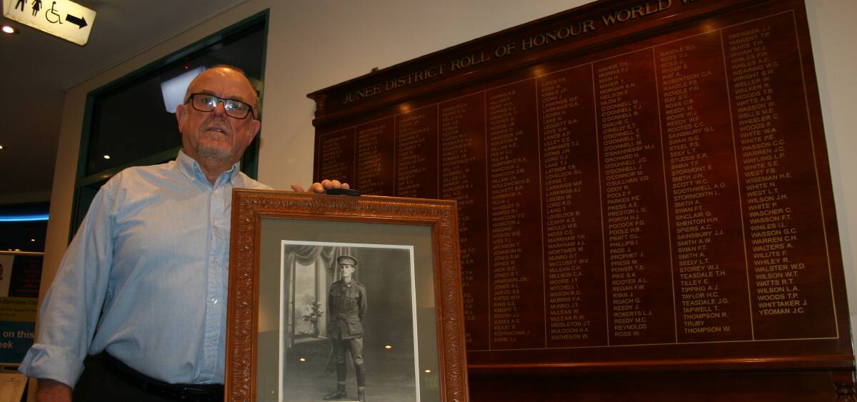 REMEMBRANCE: Ex-Services Club manager David Berry with a new roll of honour and photo of an unidentified Junee soldier which Mr Berry is hoping someone can help name.