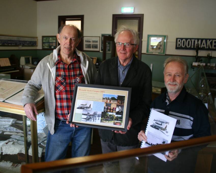 HIS STORY: Cootamundra's Robert Crick presents Jack Cooper's military history to Jack's nephew Bruce and musuem treasurer Rob Rashleigh. Picture: Declan Rurenga