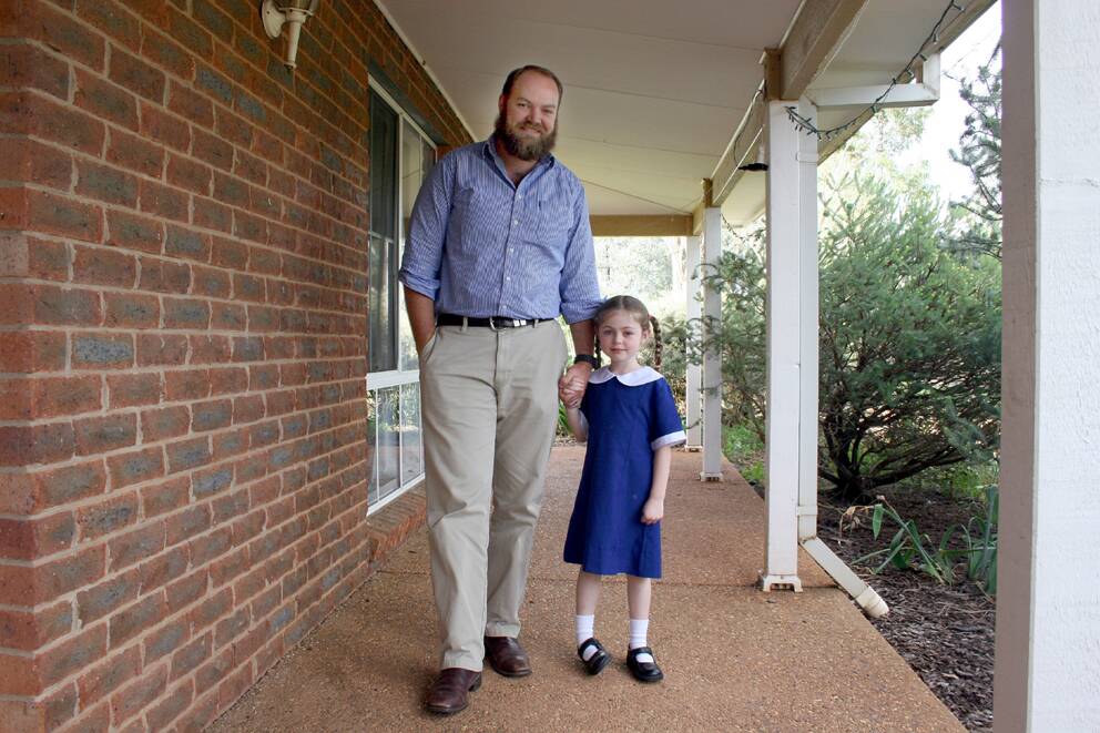 Lilly Barton, 4 with her dad Will, is one of Junee's newest school students starting kindergarten this year. Picture: Declan Rurenga