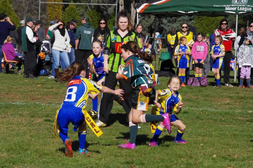 TAG! Junee's under 10 league tag players converge on a Tumbarumba/Batlow player's stripes. Picture: Kathy Matthew/Facebook