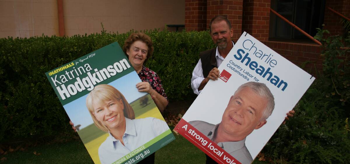TWO OF FIVE: Margaret Hill and Trevor Glover spruik their candidates at the pre-poll station at Junee's council chambers. Picture: Declan Rurenga