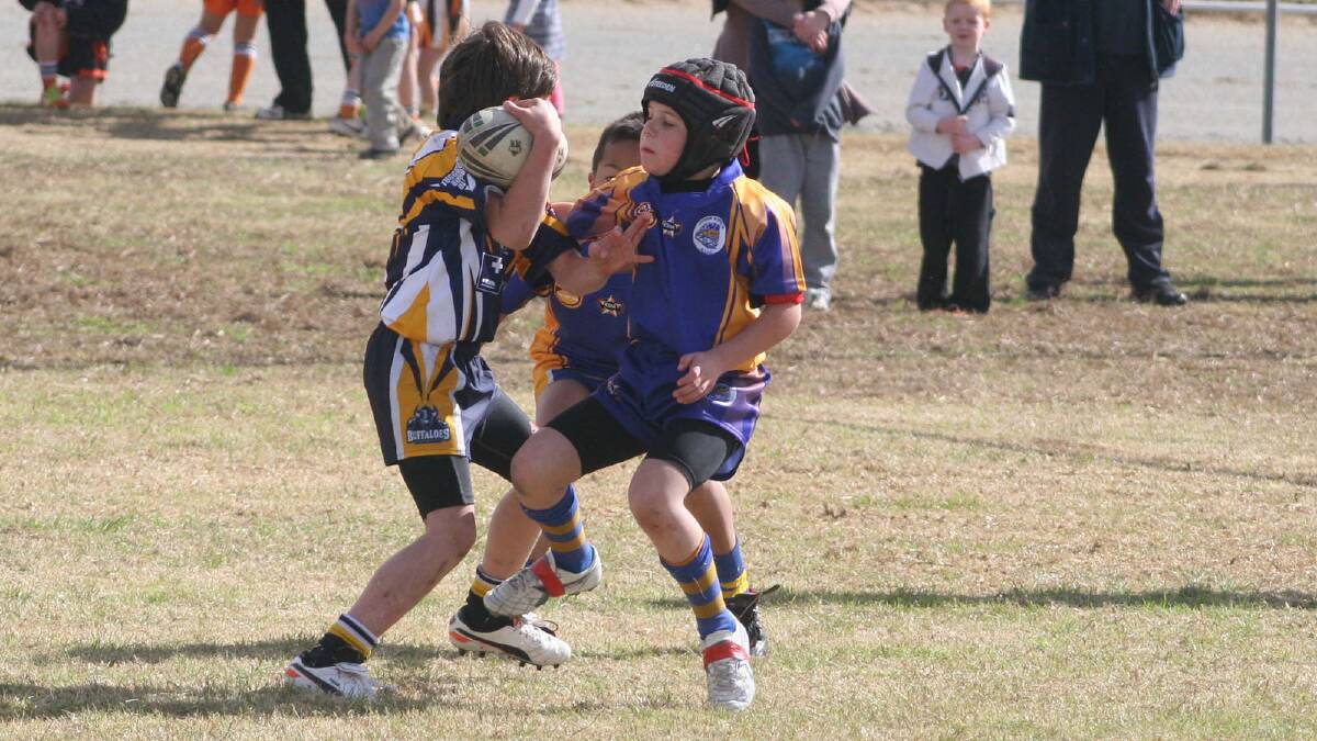 Riley Hackett gets sidestepped by the Tuggrenong attack in Under 8s.