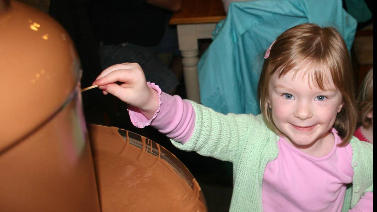 Grace Tokely, 4, from Wagga has a bit of fun with the chocolate fountain.